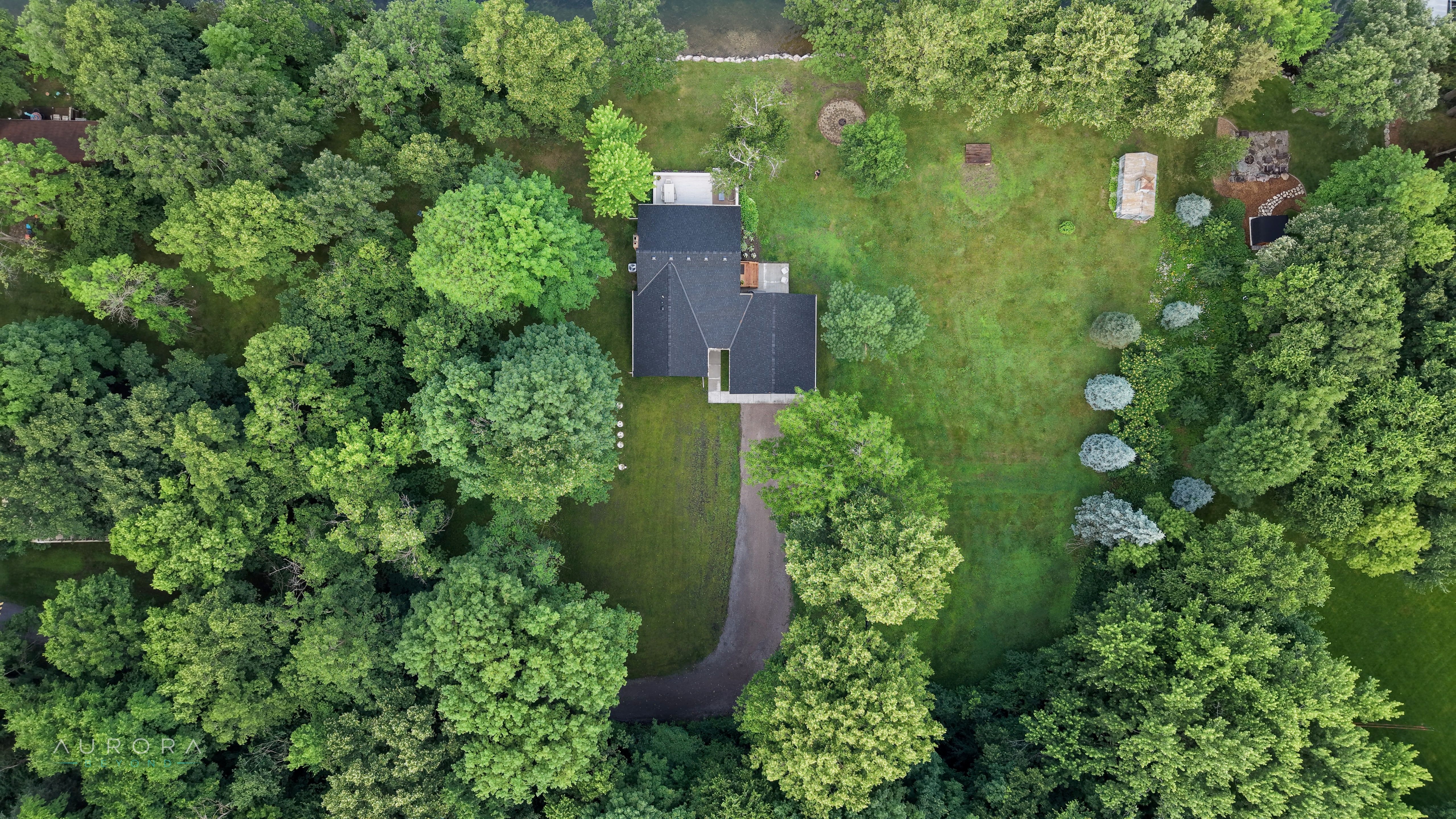 A wooded property and winding driveway seen from directly above