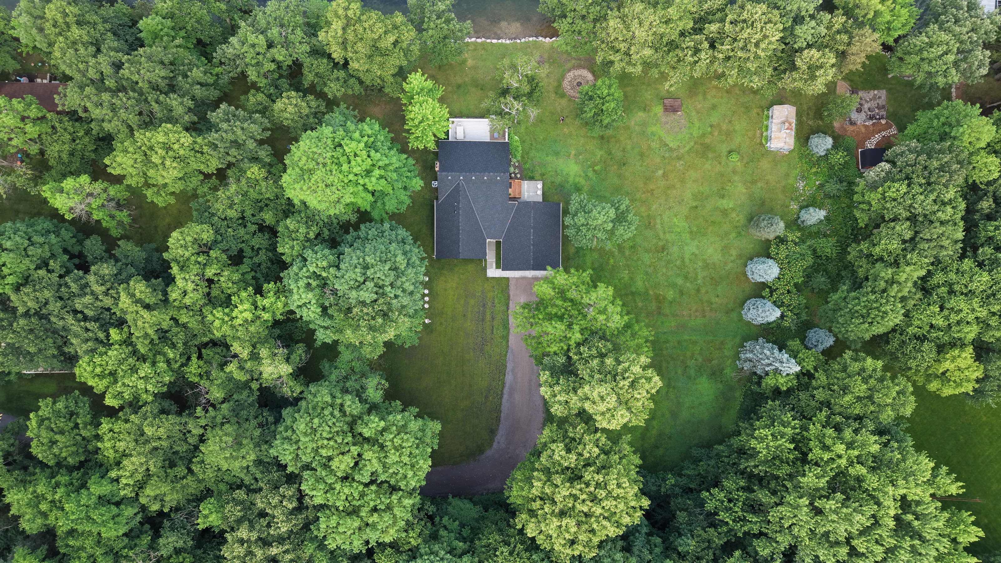 Aerial view of a wooded Minnesota property and surrounding landscape